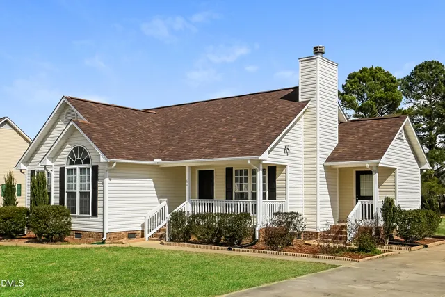 a front view of house with yard and green space