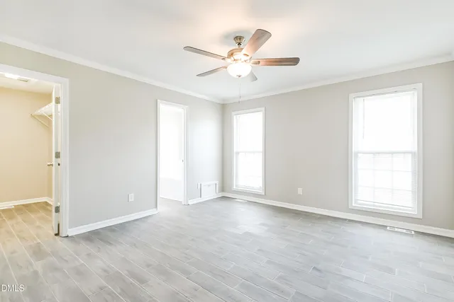 wooden floor in an empty room with a window