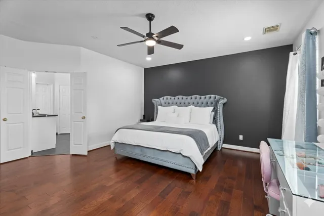 a bedroom with a bed and a ceiling fan