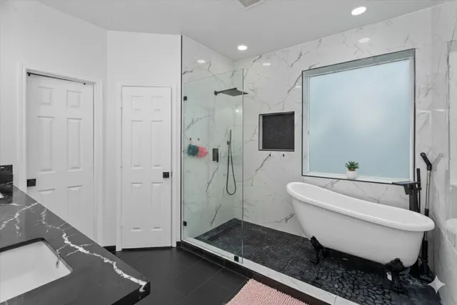 a spacious bathroom with a double vanity sink a toilet and shower