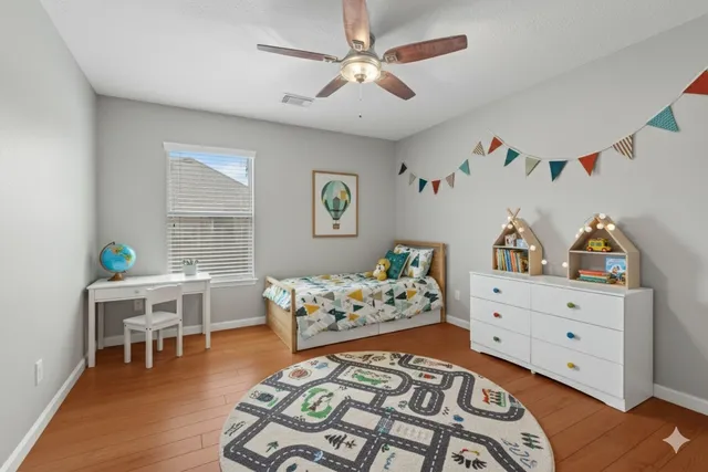 a bedroom with furniture and a wooden floor