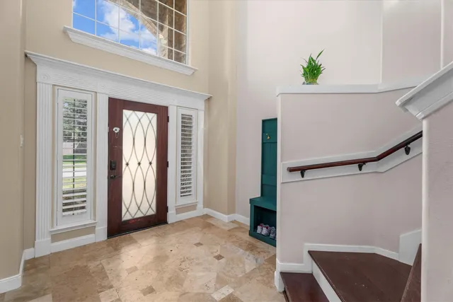 an entryway with wooden floor and cabinet