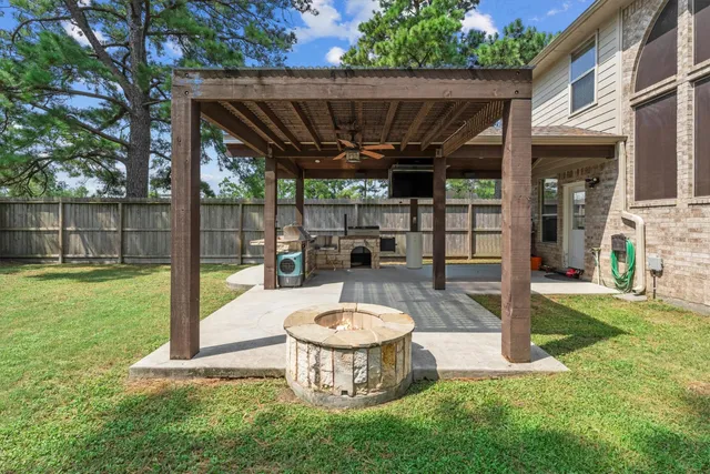 a view of a backyard with a tub and wooden fence