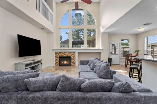 a living room with furniture a flat screen tv and a fireplace