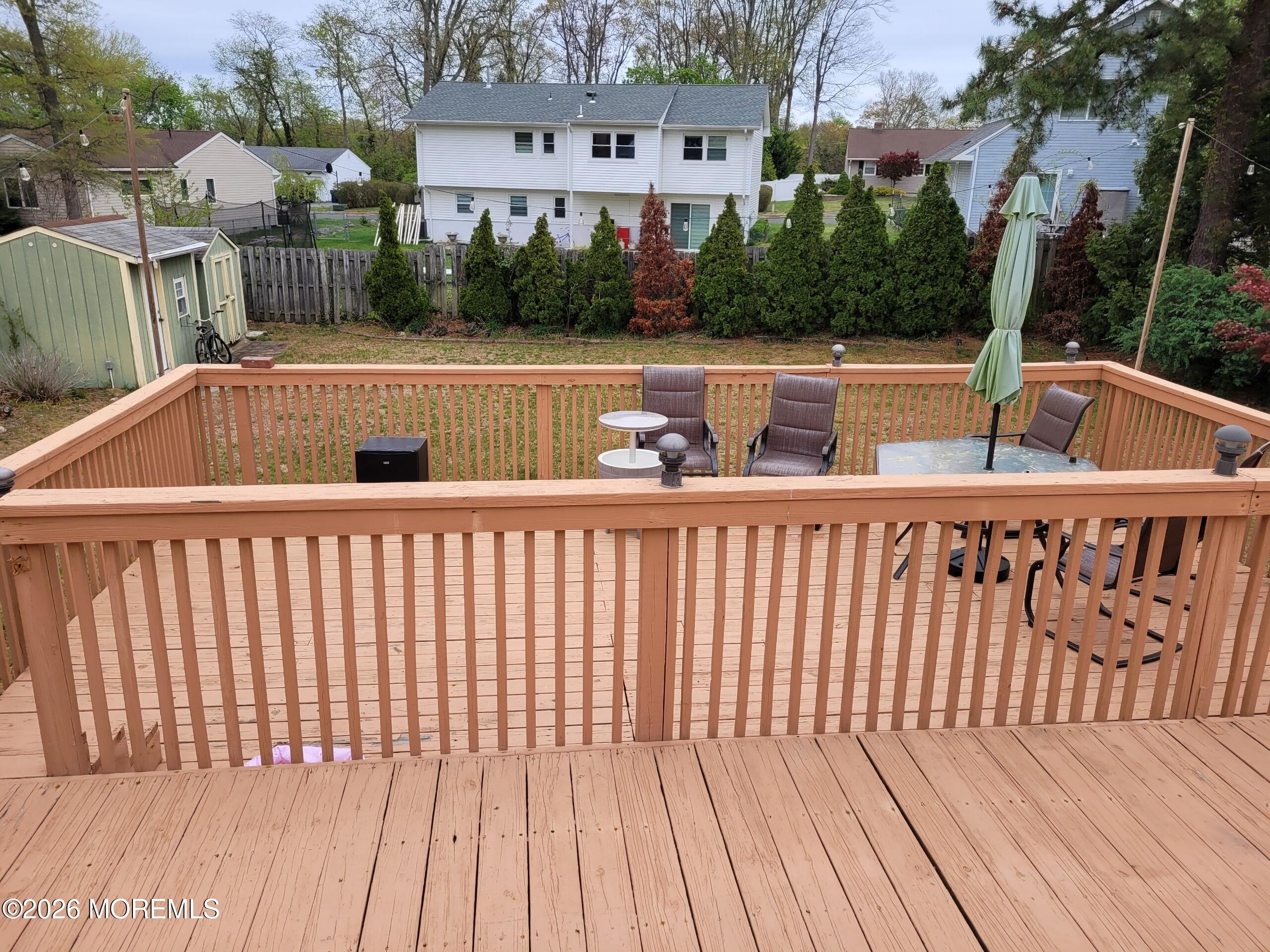 5 Peach Tree Road Oakhurst, NJ 07755 - Photo 5 of 6 a roof deck with wooden floor and fence