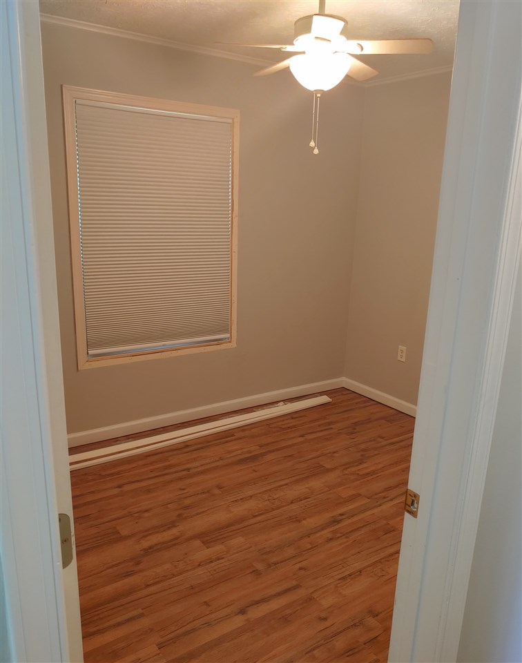 866 Augusta Farms Road Waynesboro, VA 22980 - Photo 19 of 28 en empty room with wooden floor and fan