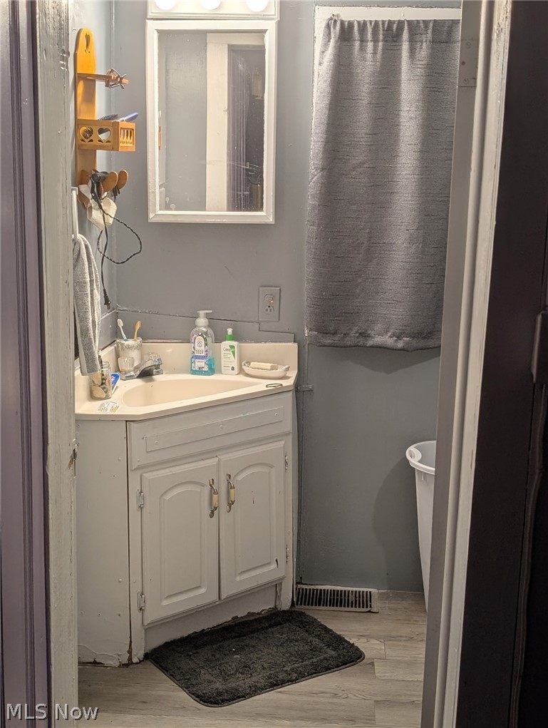 3 South 2nd Street Dennison, OH 44621 - Photo 14 of 16 Bathroom featuring vanity and light wood finished floors