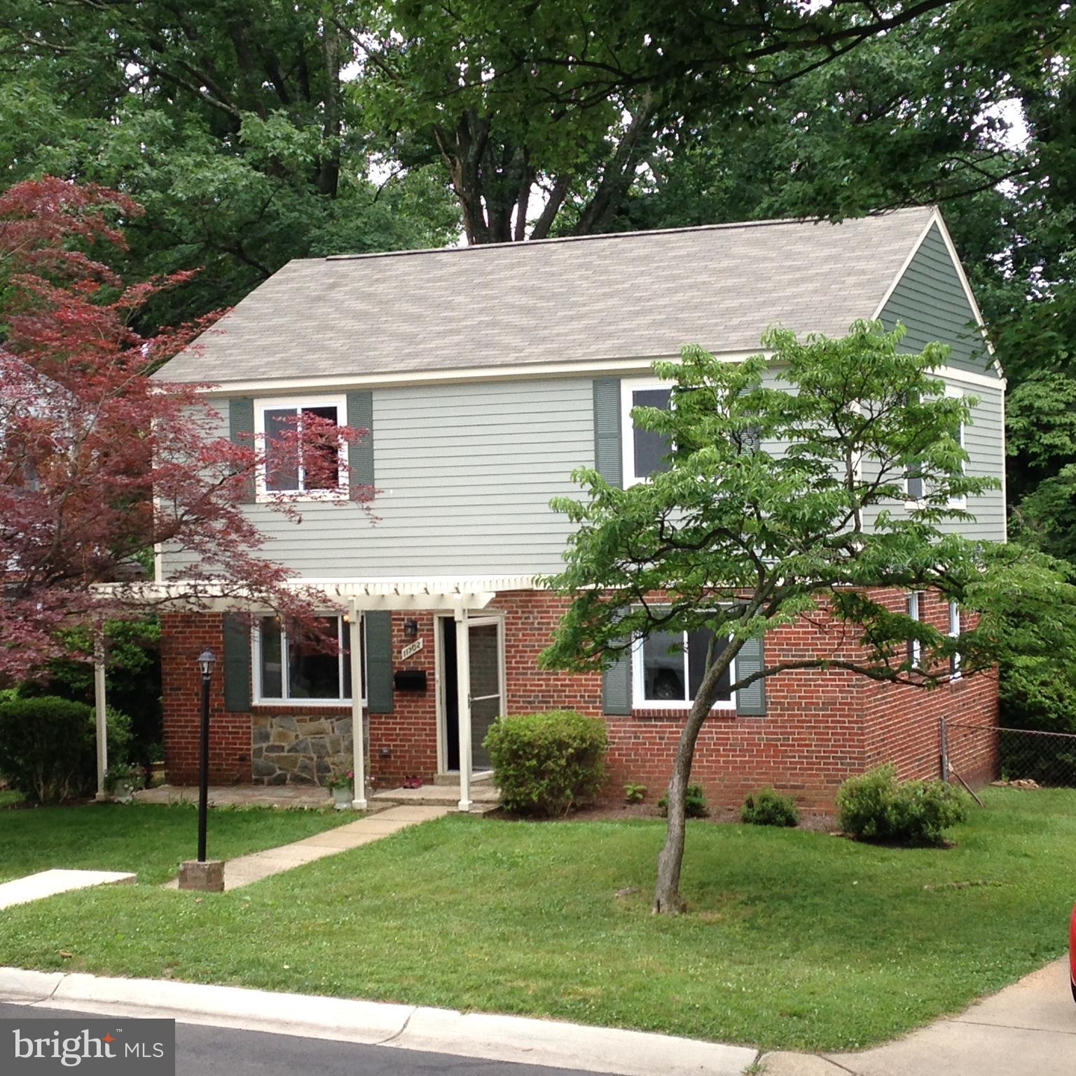 11702 Hatcher Place Silver Spring, MD 20902 - Photo 1 of 30 a front view of a house with a garden