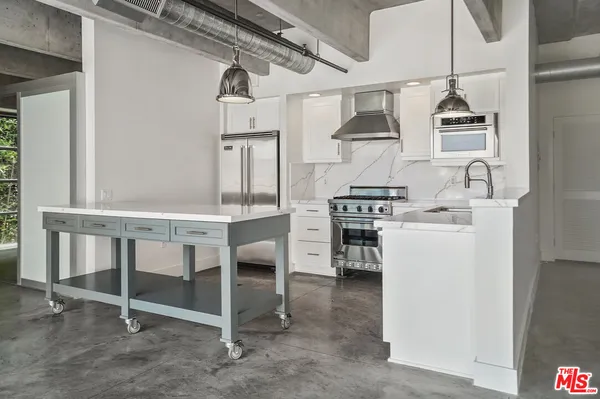 a kitchen with a table chairs stove and cabinets