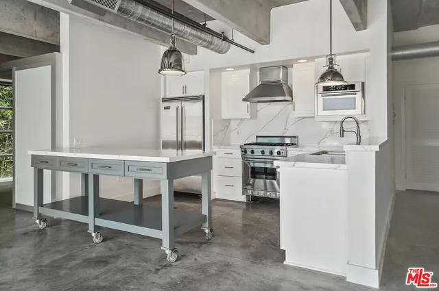 a kitchen with a table chairs stove and cabinets