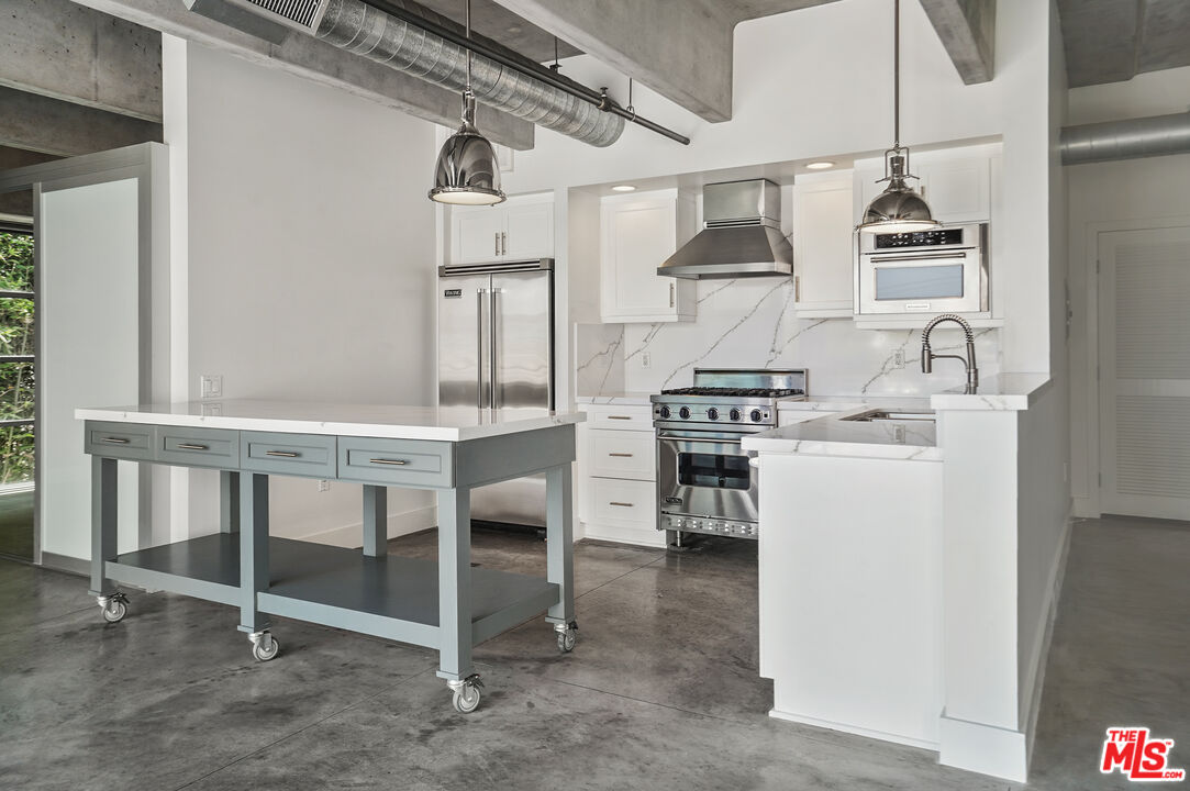 4141 Glencoe Avenue, Unit 211 Marina del Rey, CA 90292 - Photo 1 of 49 a kitchen with a table chairs stove and cabinets