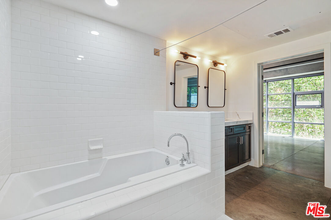 4141 Glencoe Avenue, Unit 211 Marina del Rey, CA 90292 - Photo 14 of 49 a bathroom with a tub a sink and a mirror