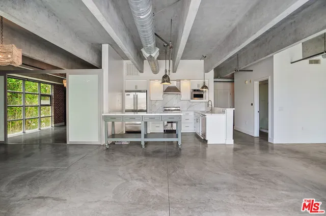 a kitchen with stainless steel appliances a stove a refrigerator and a sink