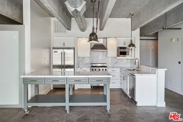 a kitchen with stainless steel appliances granite countertop a stove and a sink