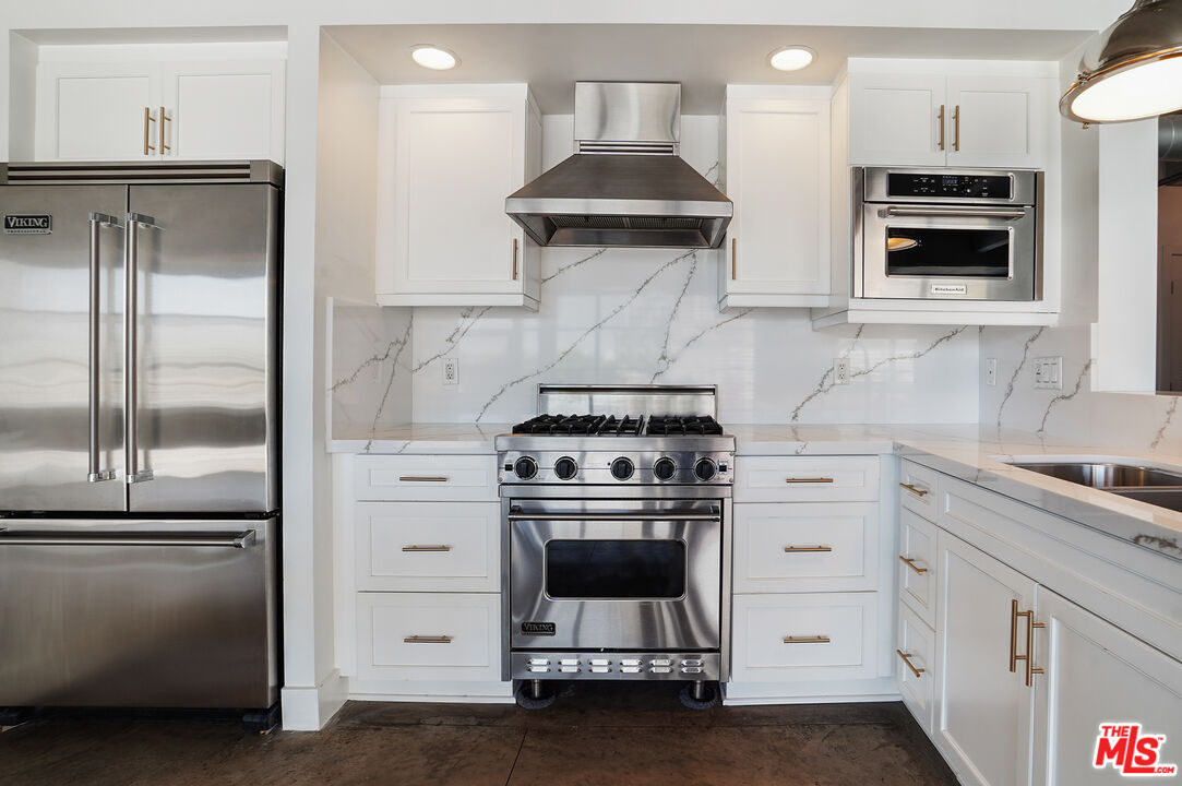 4141 Glencoe Avenue, Unit 211 Marina del Rey, CA 90292 - Photo 19 of 49 a kitchen with stainless steel appliances a stove a refrigerator and a sink