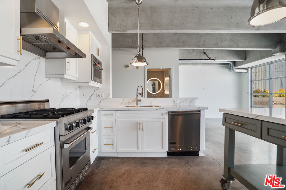 4141 Glencoe Avenue, Unit 211 Marina del Rey, CA 90292 - Photo 20 of 49 a kitchen with stainless steel appliances granite countertop a stove and a sink