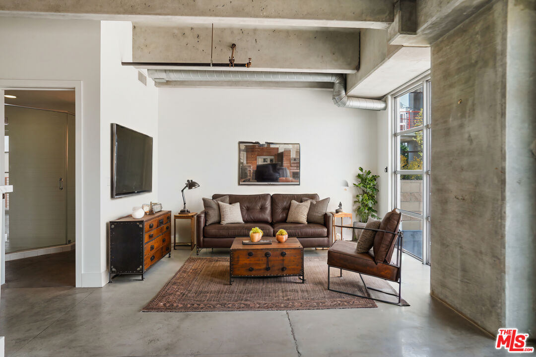 4141 Glencoe Avenue, Unit 211 Marina del Rey, CA 90292 - Photo 32 of 49 a living room with furniture and a flat screen tv