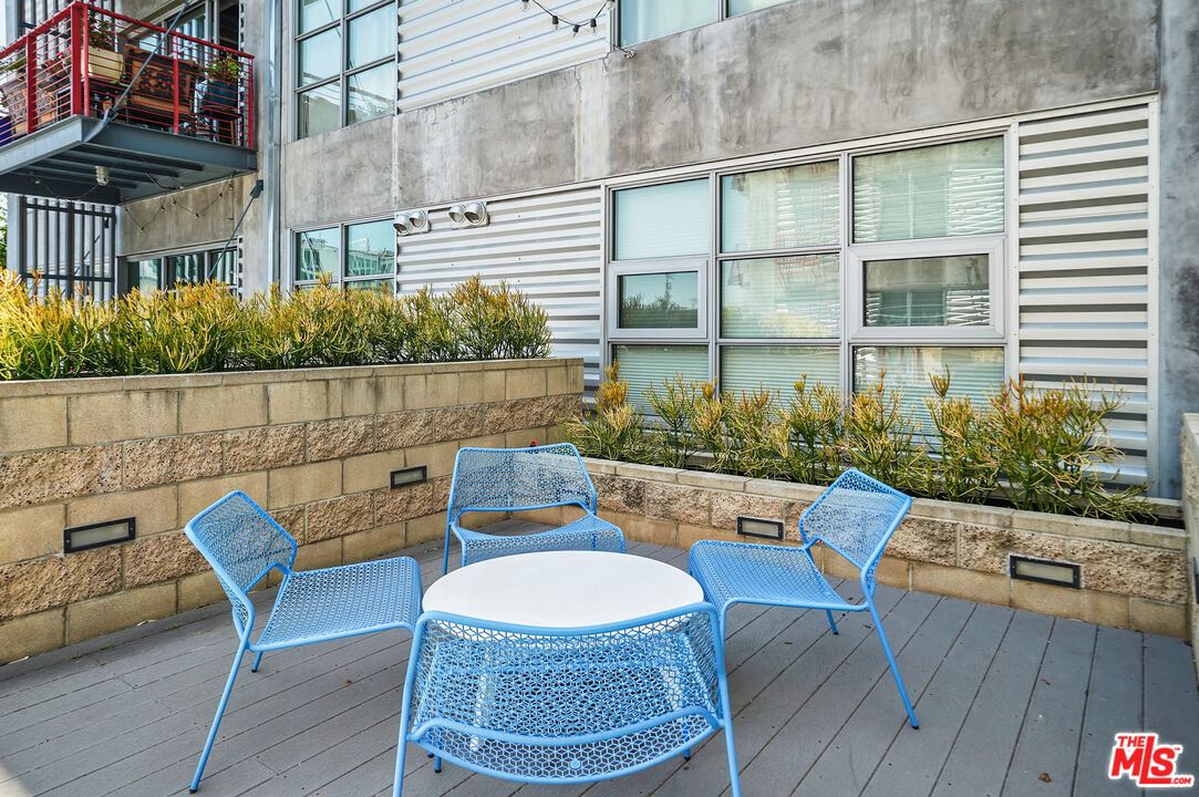 4141 Glencoe Avenue, Unit 211 Marina del Rey, CA 90292 - Photo 36 of 49 a view of a patio with table and chairs potted plants with wooden floor