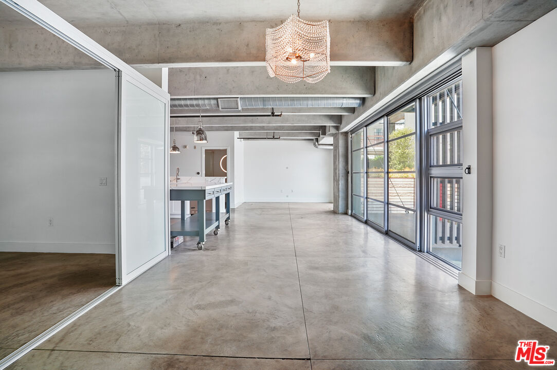4141 Glencoe Avenue, Unit 211 Marina del Rey, CA 90292 - Photo 6 of 49 a view of a hallway with wooden floor and chandelier