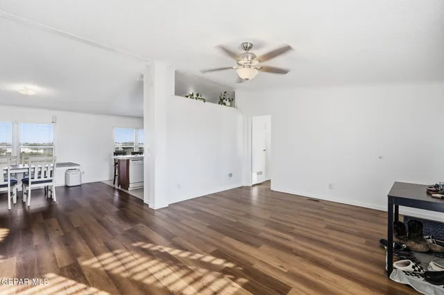 a view of a livingroom with a hardwood floor and a ceiling fan