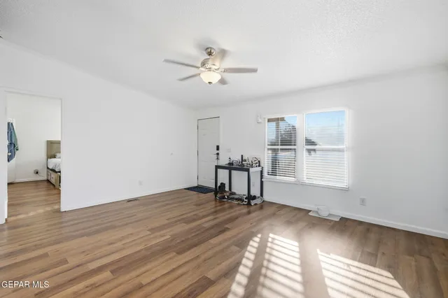 a kitchen with a dining table chairs refrigerator and cabinets