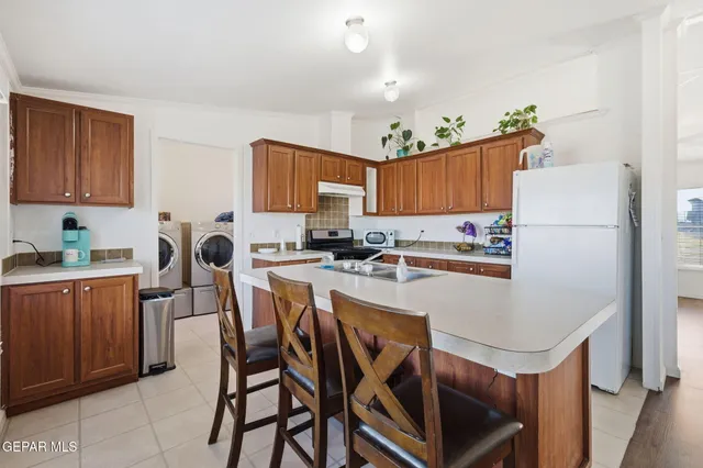 a living room with furniture a dining table and a large window