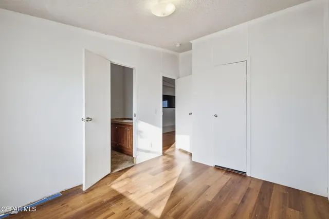 a view of room with furniture and wooden floor