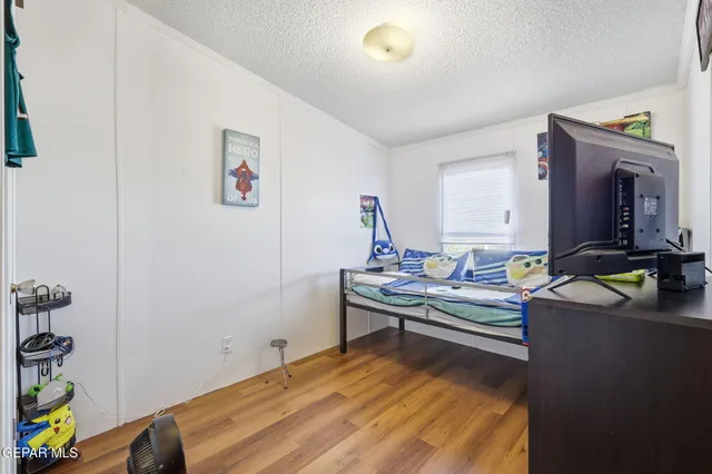 a view of a workspace with furniture and wooden floor