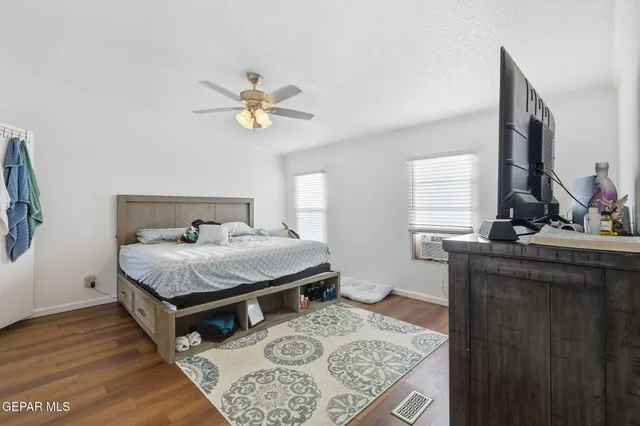 a view of room with wooden floor and gym equipment