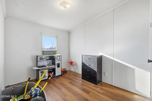 a room with hard wood floors and a bathroom