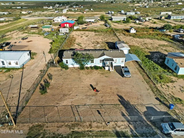 an aerial view of a houses with a yard