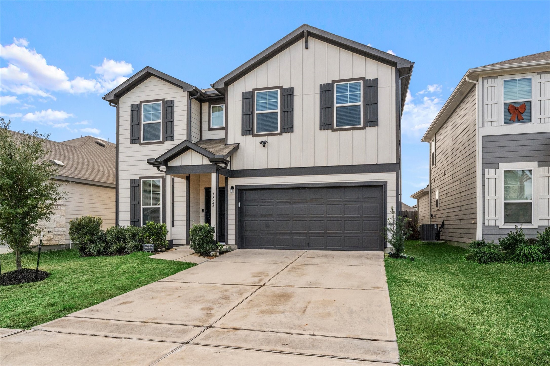 5826 Finely Run St Spring Spring, TX 77373 - Photo 2 of 38 a front view of a house with a yard and garage