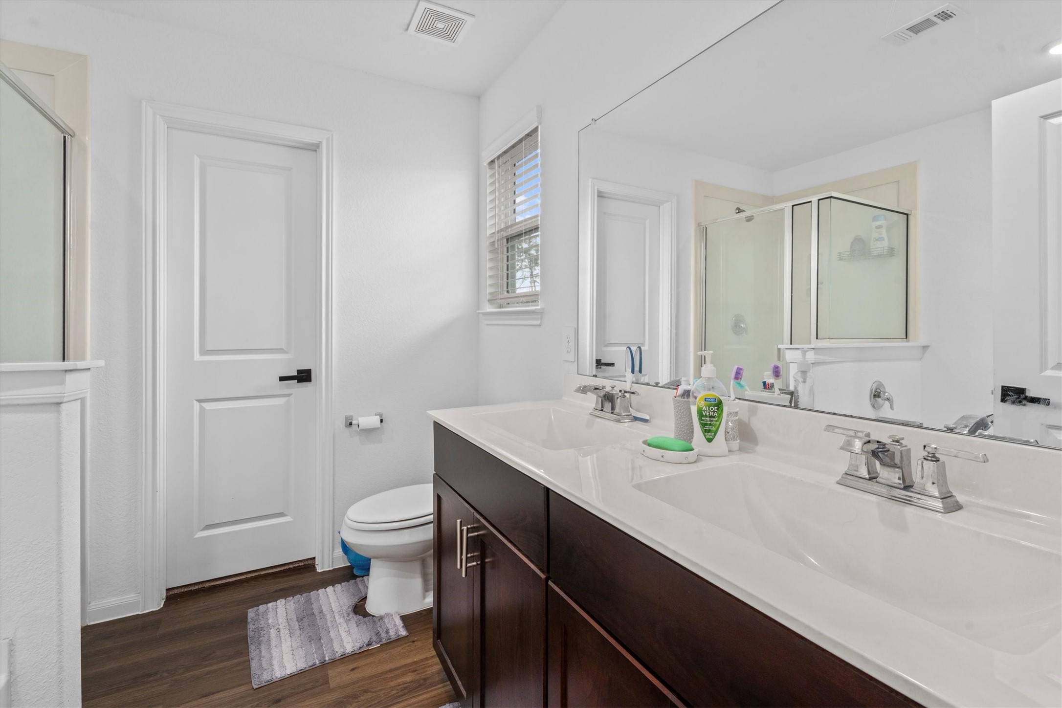 5826 Finely Run St Spring Spring, TX 77373 - Photo 29 of 38 a bathroom with a sink a toilet and a large mirror