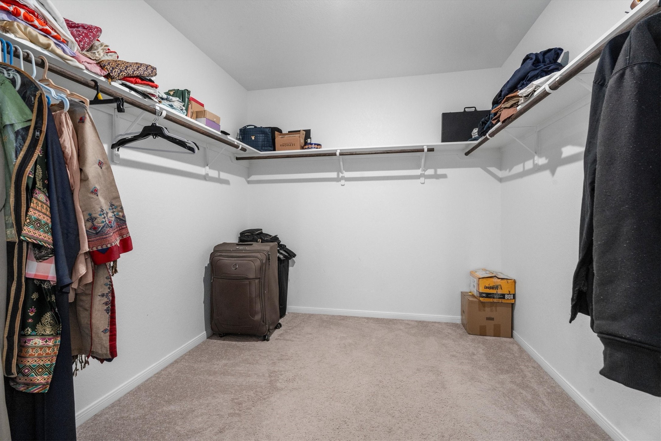 5826 Finely Run St Spring Spring, TX 77373 - Photo 31 of 38 a view of walk in closet with clothes and shoes