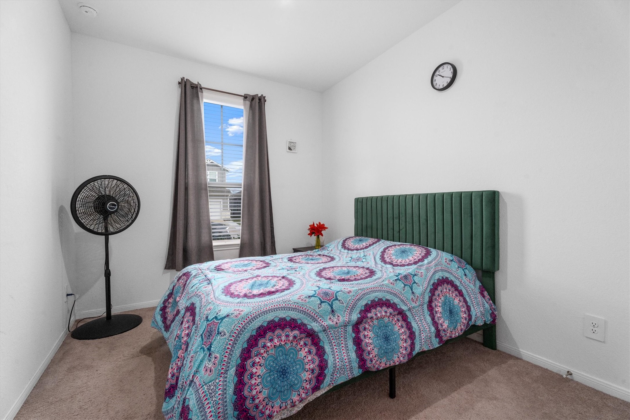 5826 Finely Run St Spring Spring, TX 77373 - Photo 6 of 38 a bedroom with a bed a clock and a window