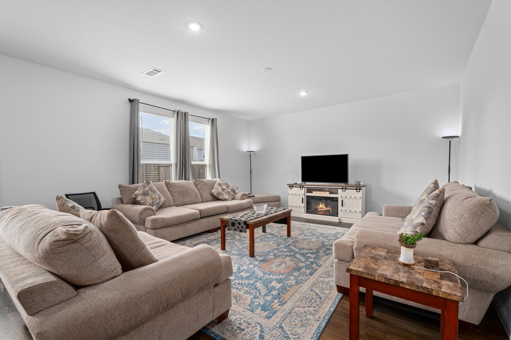 5826 Finely Run St Spring Spring, TX 77373 - Photo 9 of 38 a living room with furniture and a flat screen tv