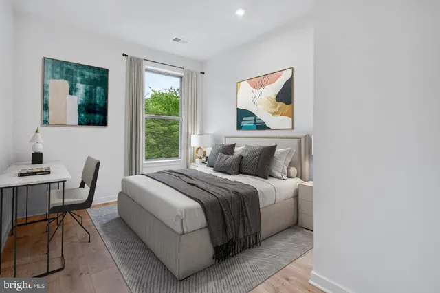 a bedroom with a bed and a window