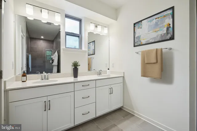 a bathroom with a double vanity sink and mirror