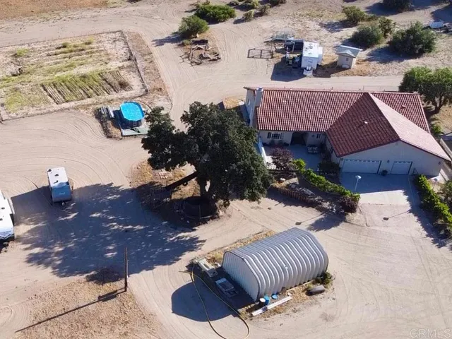 an aerial view of a house with garden space and street view