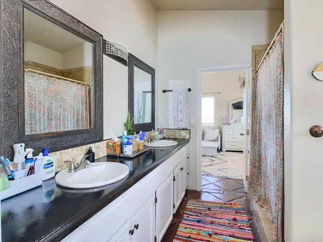 a spacious bedroom with a bed and a dresser