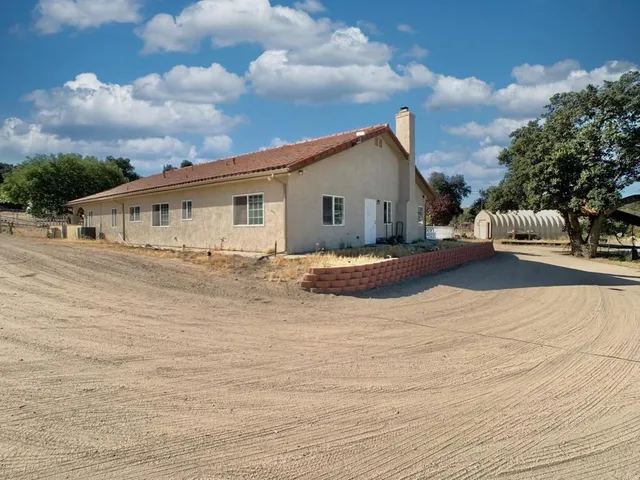 an aerial view of a house with a patio
