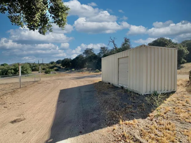a view of a bench with wooden fence