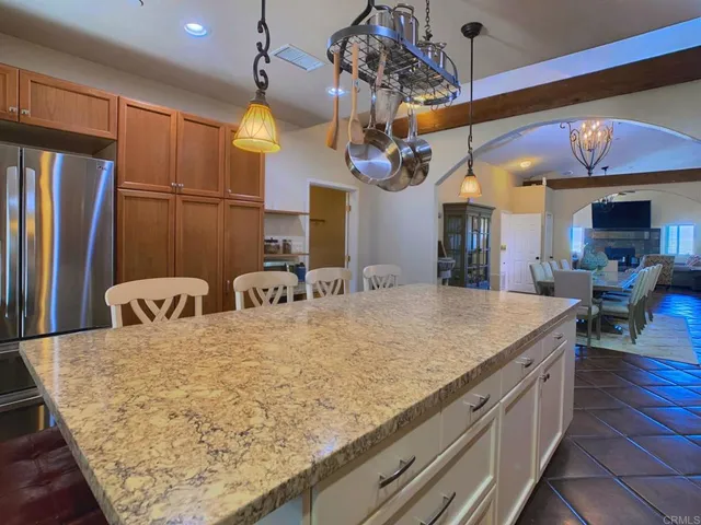 a kitchen with stainless steel appliances granite countertop a sink a stove and a wooden cabinets