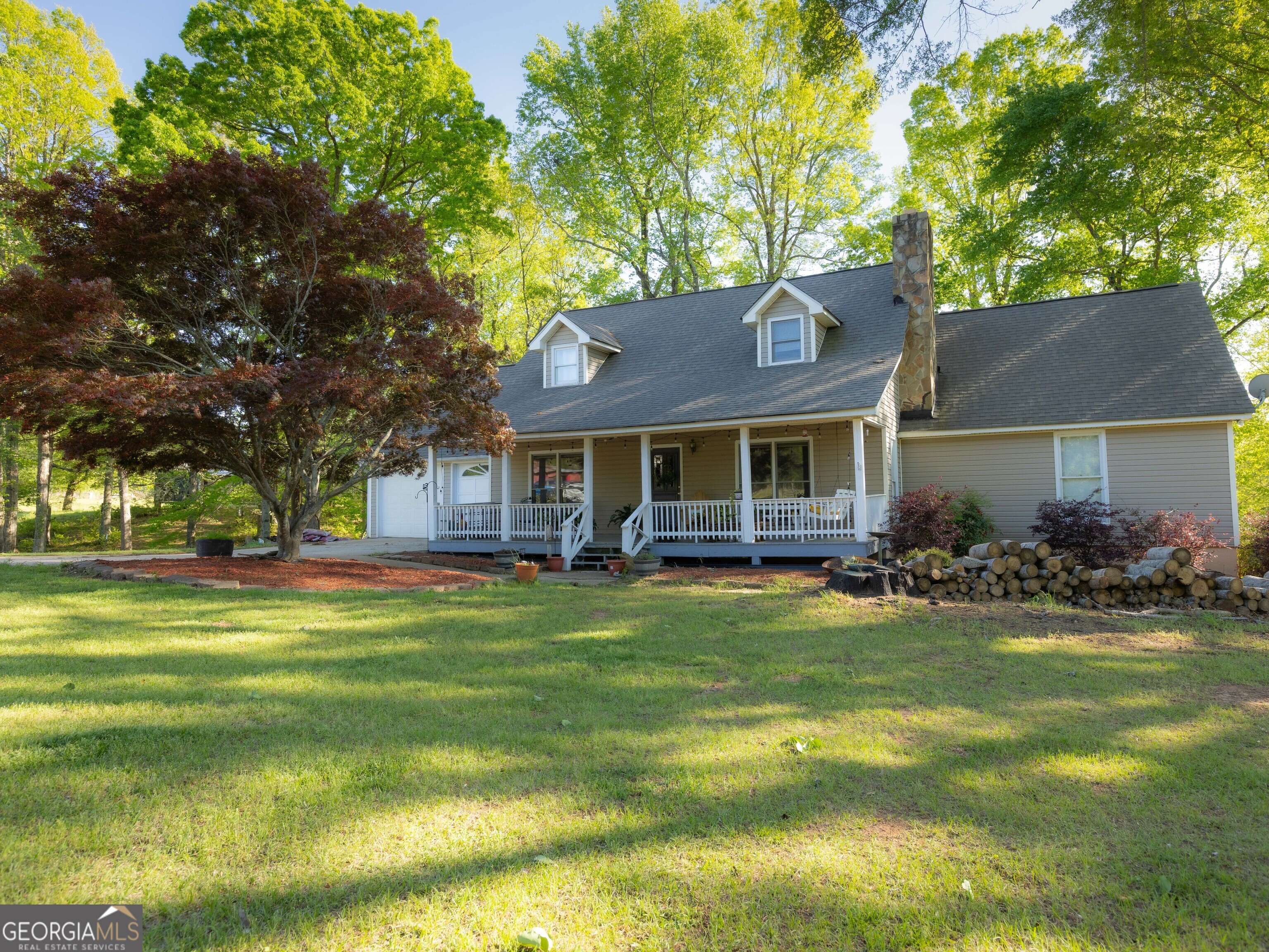 201 Little New York Road Carrollton, GA 30116 - Photo 2 of 29 a front view of a house with a garden