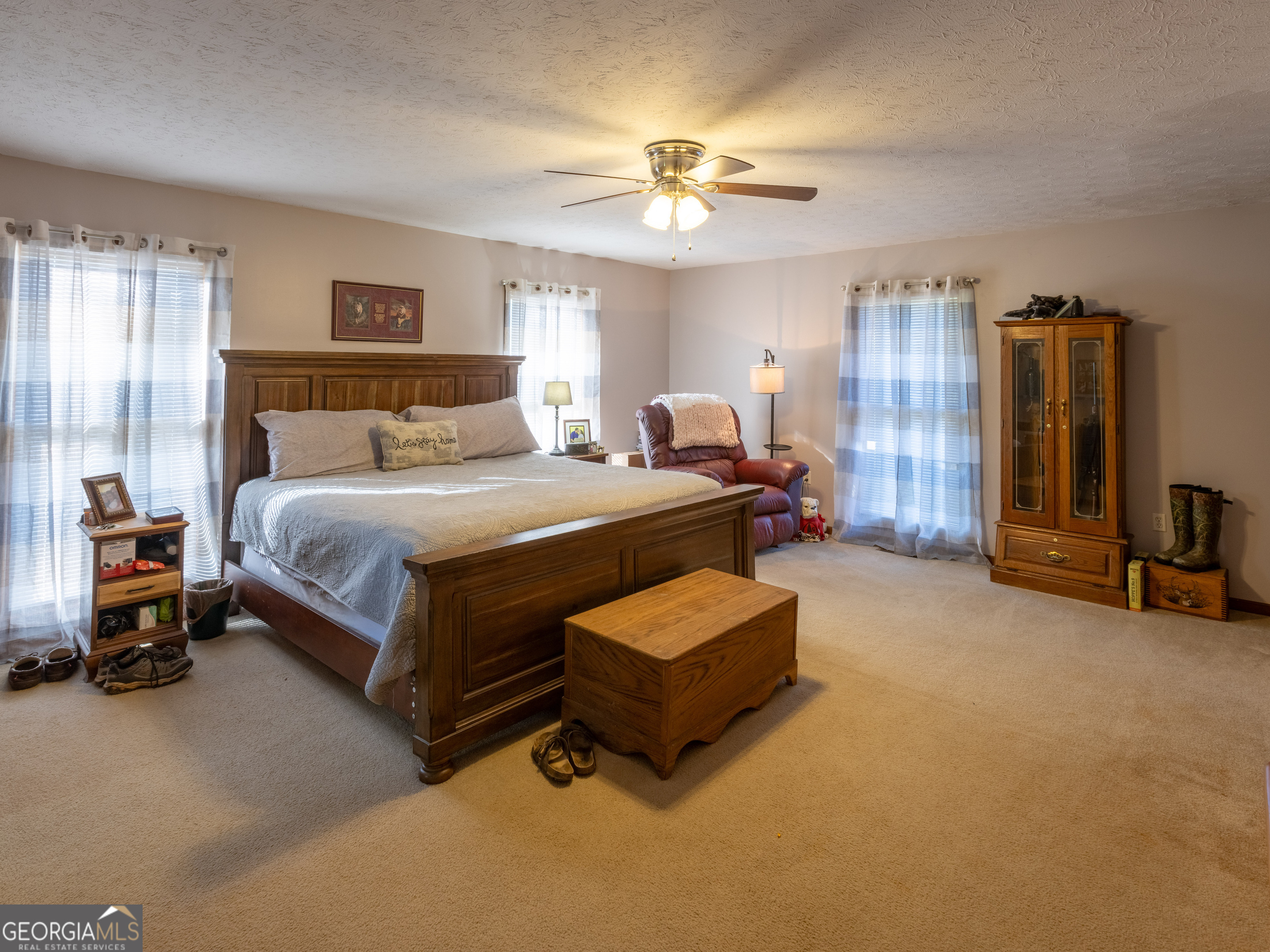 201 Little New York Road Carrollton, GA 30116 - Photo 25 of 29 a bedroom with a bed and a chandelier