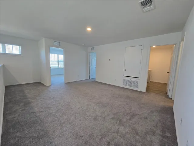 an empty room with windows and closet