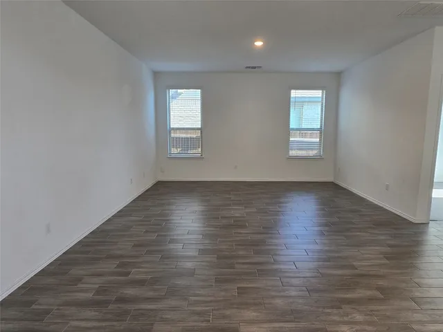 a view of room with window and wooden floor