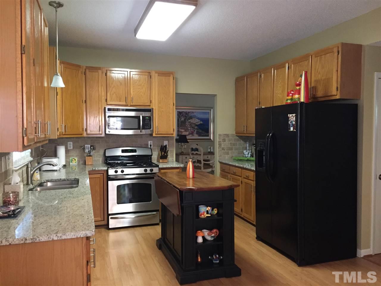 11917 Eagle Bluff Circle Raleigh, NC 27613 - Photo 11 of 25 a kitchen with stainless steel appliances granite countertop a refrigerator stove and sink