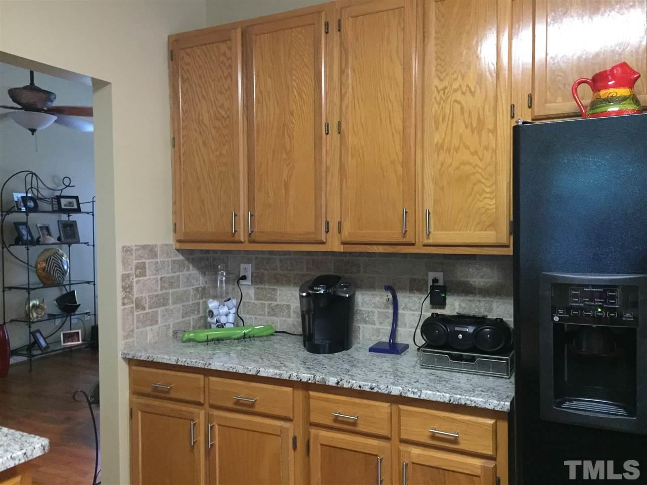 11917 Eagle Bluff Circle Raleigh, NC 27613 - Photo 12 of 25 a kitchen with stainless steel appliances granite countertop a sink a stove and cabinets
