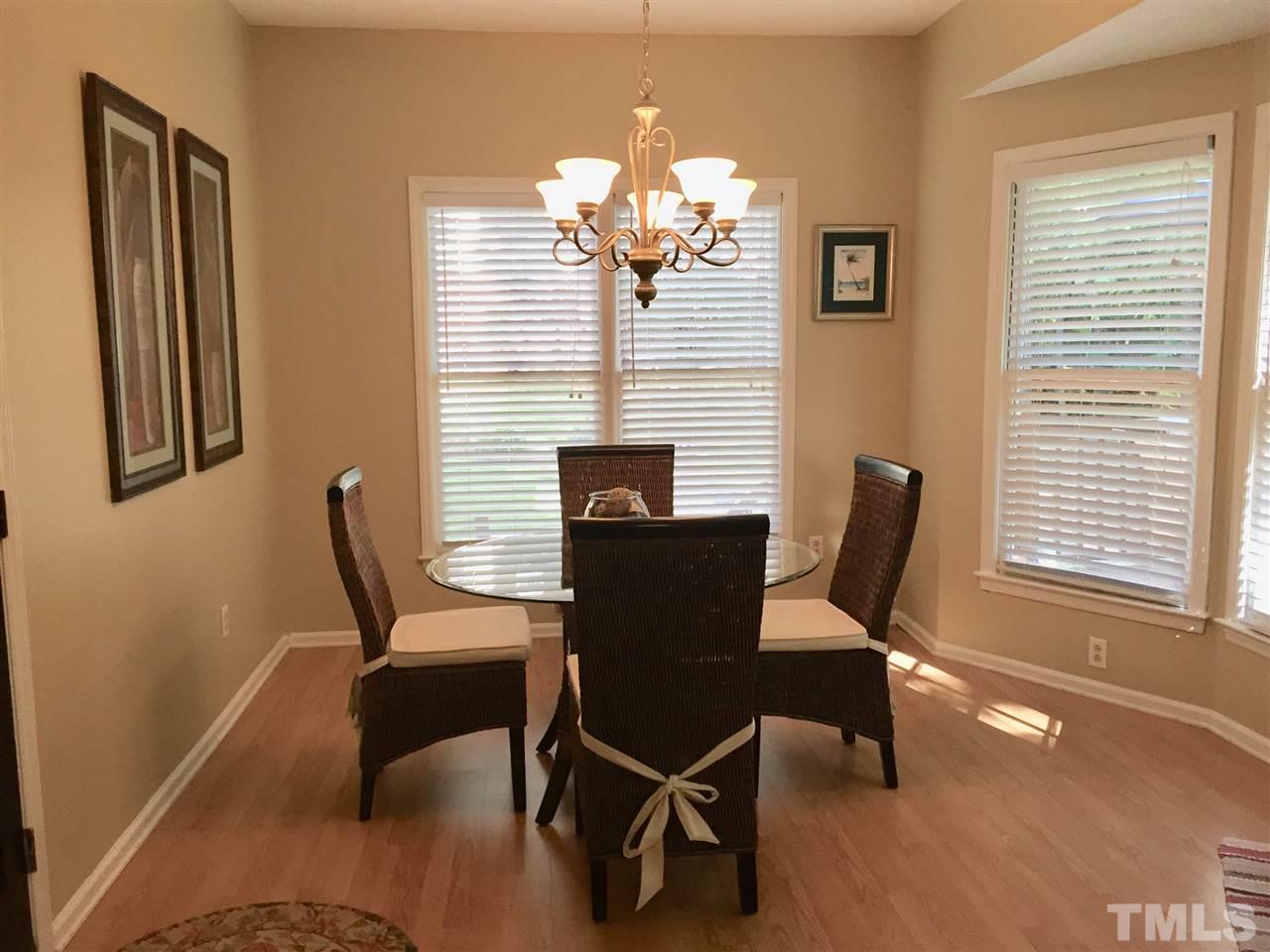 11917 Eagle Bluff Circle Raleigh, NC 27613 - Photo 13 of 25 a view of a dining room with furniture and chandelier